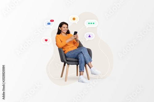 Konstfotografi A woman is sitting in a chair and using her smartphone