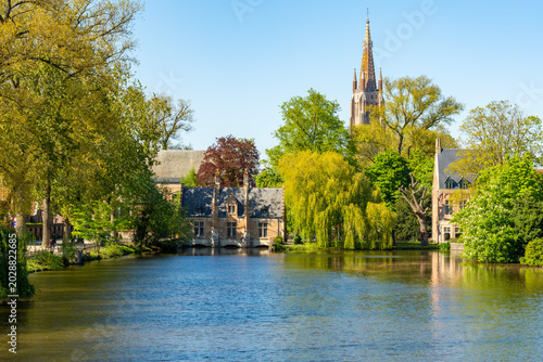 Fotografie Church of our Lady tower and Lake of Love in Brugge, Belgium
