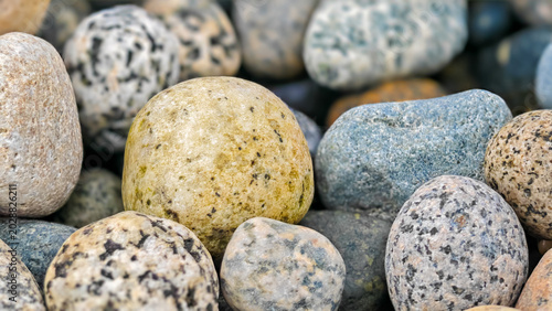 Photography Pile of rounded stones with speckled surfaces