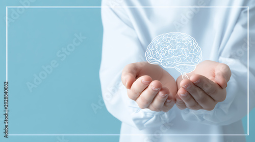 Hands holding paper brain symbol on blue background, representing mental health awareness, psychology, emotional wellbeing, cognitive care and mindfulness support