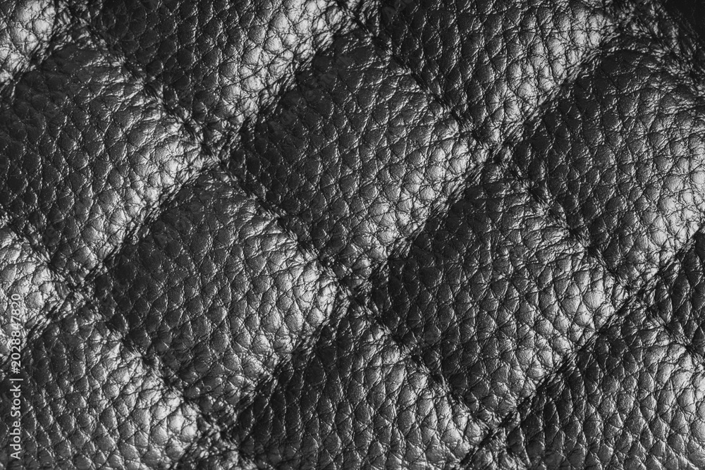 Obraz premium Close up, macro of gray quilted leather texture with stitched diamond pattern, luxury material surface shining metal effect for fashion, upholstery or design wallpaper, rough, relief background