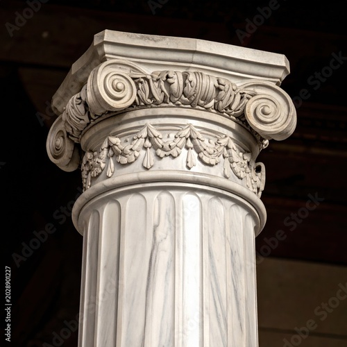 Close up of an ornate neoclassical marble column with intricate ionic capital and carved floral garland detail, historical architecture, classical sculpture, ancient building element