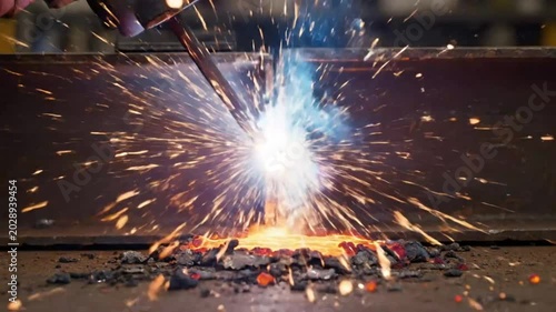 Bright welding process with sparks and molten metal creating an intense work of industrial artistry