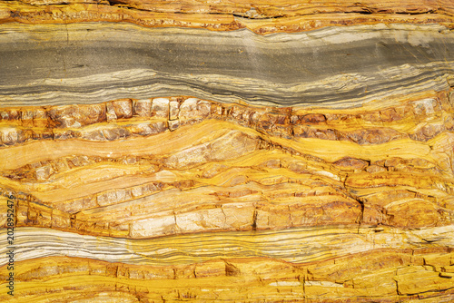 View of the geological rock formations and layered sediment at Silence Beach in Asturias, Asturias, Spain.