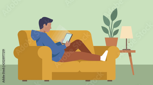 Foto Person browsing tablet while relaxing on sofa