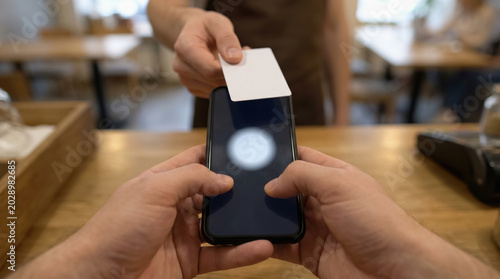 Instant payment nfc smartphone at cafe counter