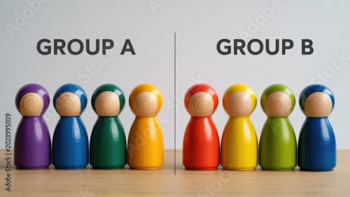 Two sets of colorful wooden peg dolls divided into Group A and Group B for categorization or research study.