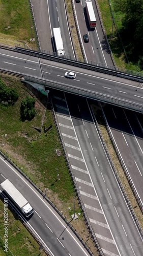 Highway Interchange Aerial View: An aerial perspective captures the complex network of a highway interchange with vehicles navigating the elevated roads and on-ramps.
