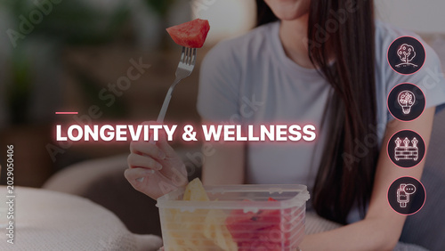 Asian women eating healthy fresh strawberry fruit salad for longevity wellness lifestyle balanced diet nutrition at home promoting healthy habits fitness