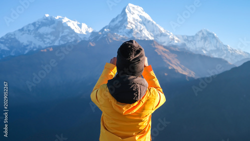 A woman traveler with machapuchare peak, annapurna mountain range in pokhara , nepal