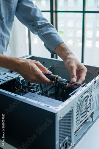 Asian IT engineer using screwdriver fix pc case