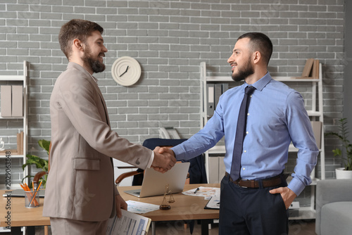 Happy businessmen shaking h...