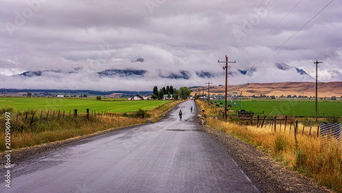Foto Bicycles On A Back Road On A Rainy Morning