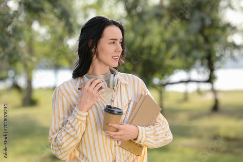 Pretty young woman with cup...