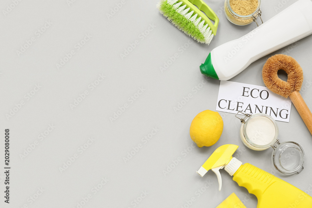 Obraz premium Paper sheet with text ECO CLEANING and different supplies on grey background