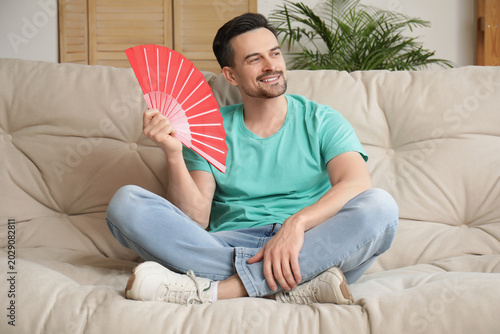 Handsome young man with fan...