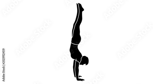 Silhouette of a person performing a handstand exercise.
