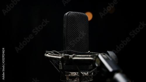 Foto Professional Studio Condenser Microphone on Shock Mount Against Black Background