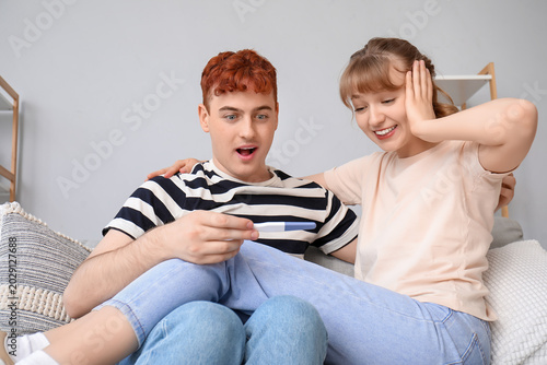 Happy young couple with pre...