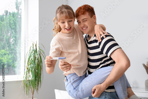 Happy young couple with pre...
