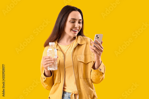 Young woman with bottle of ...