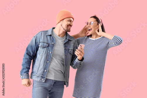 Happy young couple with mob...