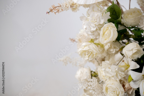 Detail with white japanese vibe umbrela, Elegant white flowers cascade upward in graceful tiers. Delicate blooms and soft petals frame a clean, minimalist backdrop. Neutral tones enhance purity