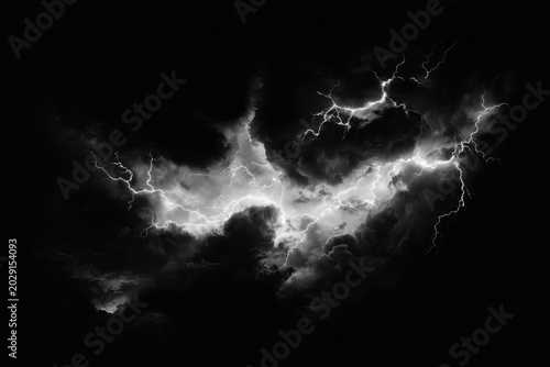 Dramatic lightning strike in dark storm clouds, powerful electrical discharge in night sky, monochrome weather phenomenon with bright white flashes