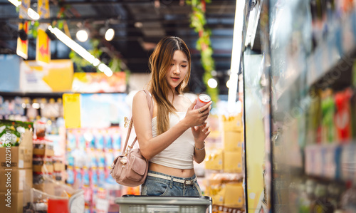 Photography Young adult asian woman consumer choosing beverage refreshment drink at asia sup