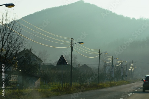 electric lamps on poles by the road and wires