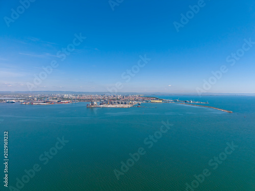 City view from above over water with ships and buildings in the distance