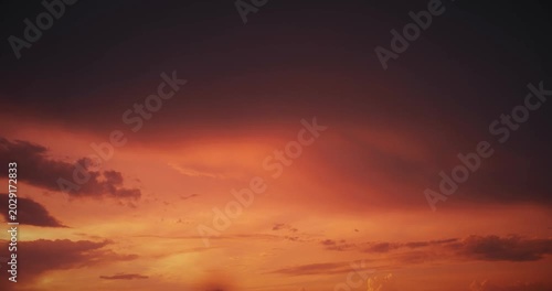 Dramatic Twilight Skies with Fiery Clouds Above Horizon
