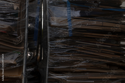Tableau sur toile Compressed cardboard loads wrapped in film with creases and scuffs, shipping dam