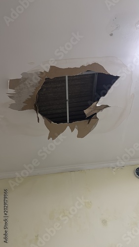 A GRC ceiling collapsed on the roof of the house. A large hole in the ceiling of the house was caused by a leaking roof tile.