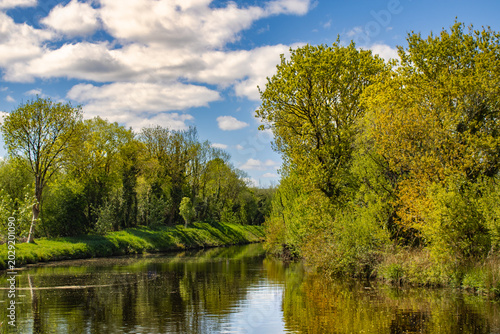 Canal reflections and green trees along the Shannon Blueway near Drumshanbo Ireland