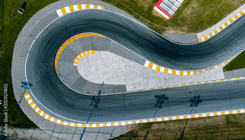 Aerial view of a winding race track with yellow and white markings.