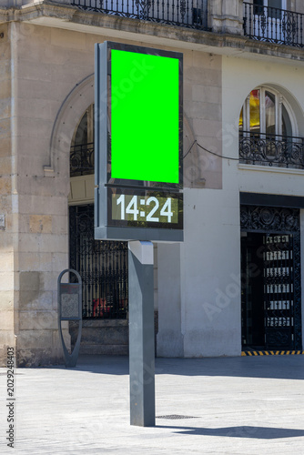 Digital billboard with green screen mockup on city street