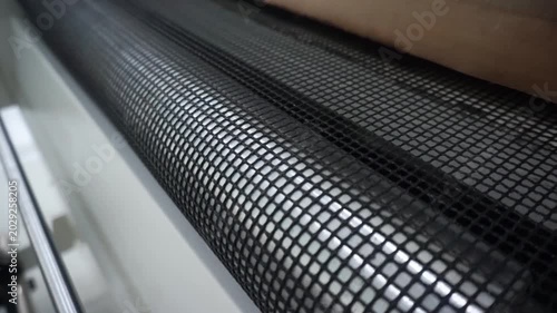 The conveyor mesh rotating on the DTF screen printing heating machine, Still Shot