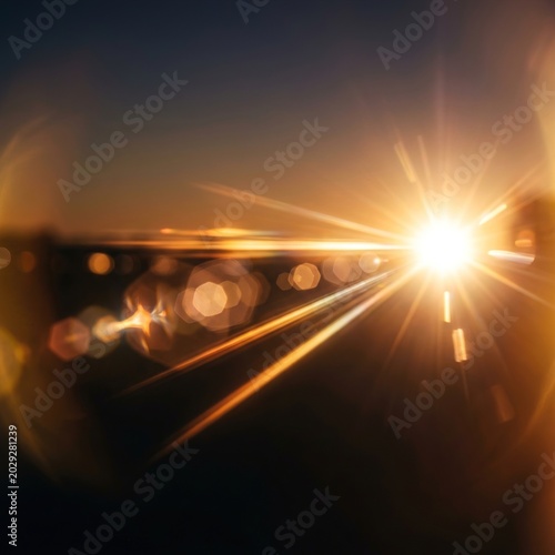 Golden sunrise lens flare with bokeh effect