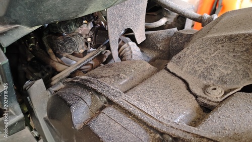 Photos Motorcycle engine compartment closeup with dusty mechanical parts and industrial details