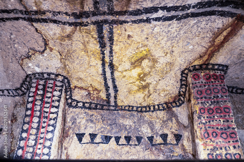 Colombia, inside a Burial chamber in Tierradentro, pre-columbian carvings depicting faces and patterns, 