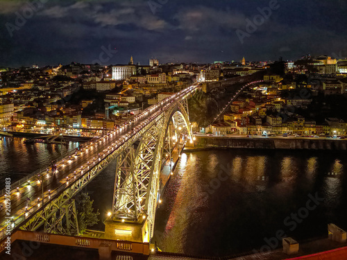 Dom Luís I Bridge illuminated at night and colorful buildings on the hill, Porto PORTUGAL 
