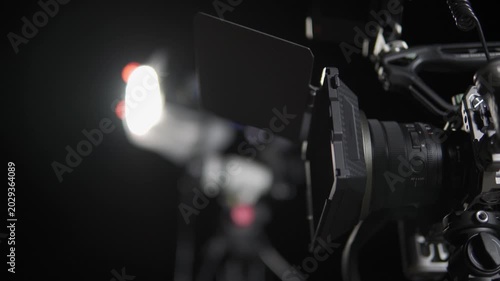 Professional cinema camera on a film set with lighting equipment