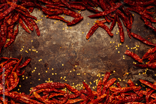 Red, dried bird's eye chili or Thai chilli peppers, hot and spicy Capsicum for sambal, chile sauces, pastes, marinades, condiments for cooking Asian cuisine dishes, top down view, space for copy text