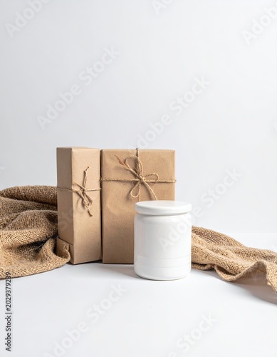 Gifts and jar set on a white surface with fabric