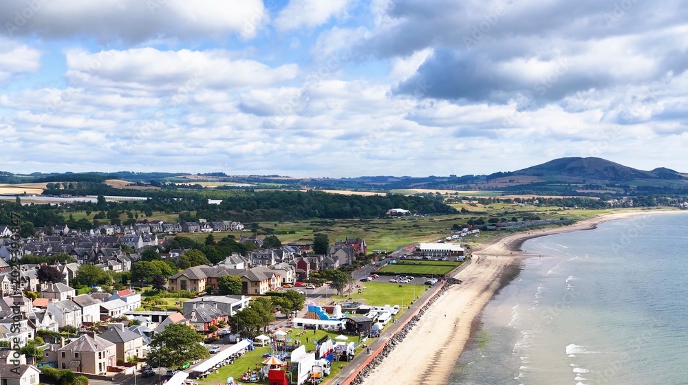 Fototapeta premium Aerial View of Fife Coastal Town with Sandy Beach and Hills