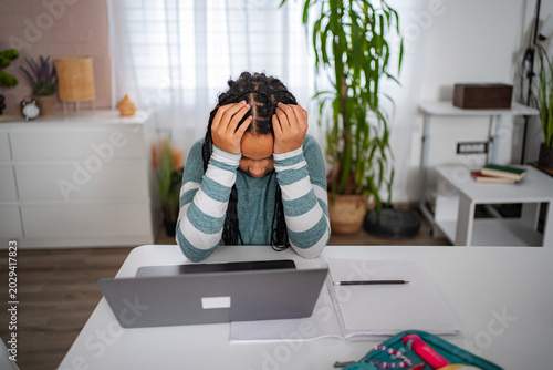 Photos Frustrated student having headache during online studying
