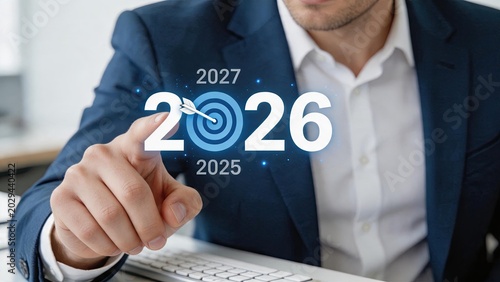 Businessman planning goals and targets for year 2026 with arrow hitting bullseye center, strategic vision timeline concept showing future planning for 2025 and 2027 fiscal periods