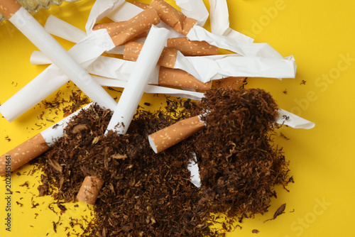 Cigarettes, tobacco and ashtray pile of cigarettes concept of smoking ban.
