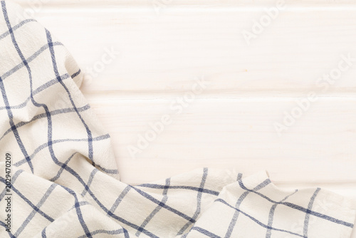 Kitchen napkin on wooden background, top view